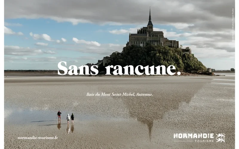 Campagne « Rien que la Normandie » : le Mont-Saint-Michel vu depuis la baie, avec l’accroche « Sans rancune ».